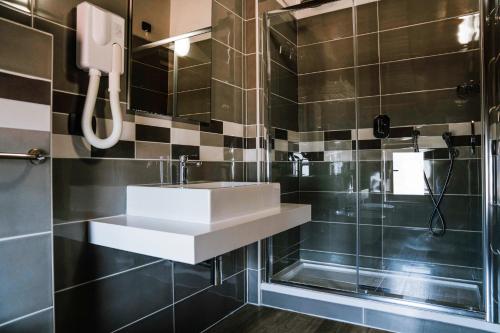 a bathroom with a sink and a shower at Agriturismo Cascina del Vai in Cairo Montenotte