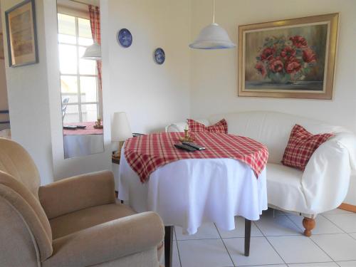 a living room with a table and two chairs at Ferienwohnung-Moltrecht-2 in Laboe