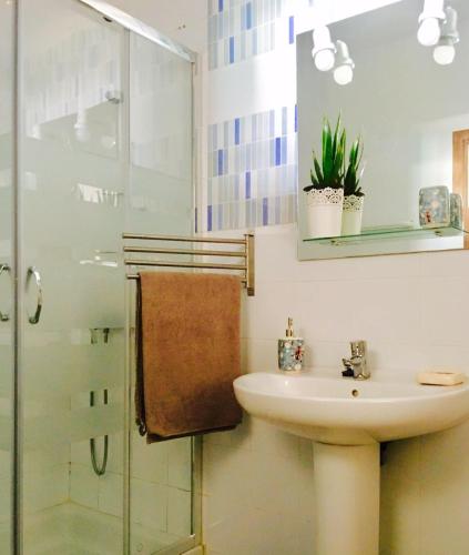 a bathroom with a sink and a shower at La Santa Feel Good in La Santa