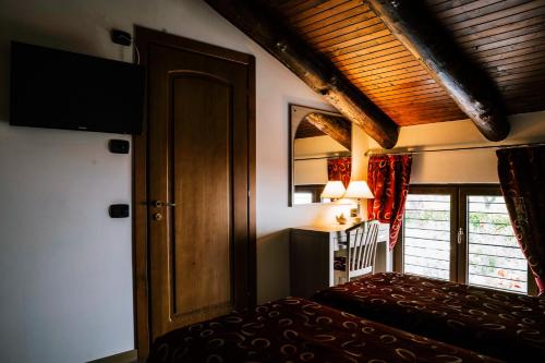 a room with a bed and a door and a window at Agriturismo Cascina del Vai in Cairo Montenotte