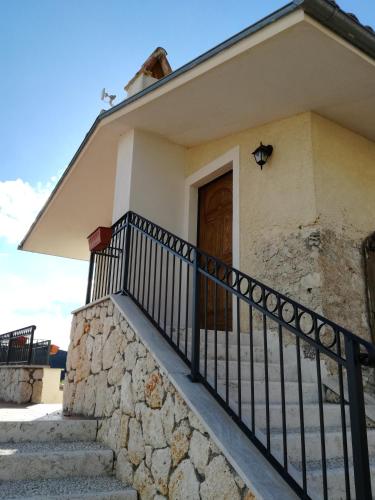 a house with stairs and a wooden door at Cominium Benessere in Alvito