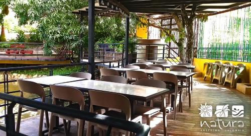 a row of tables and chairs in a restaurant at Natura Reservado - Hoteles Natura in Anapoima