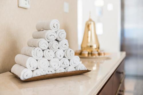 a pile of towels on a counter in a bathroom at Jannah Marina Hotel Apartments in Dubai
