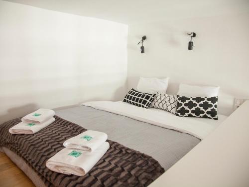 a bedroom with a bed with towels on it at BC7 Apartments in Krakow