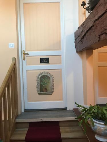 a door with a window with a plant on it at Résidence La Beauceronne in Ouarville