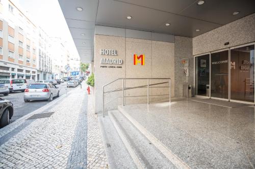 a building with a m sign on the side of it at Hotel 3K Madrid in Lisbon