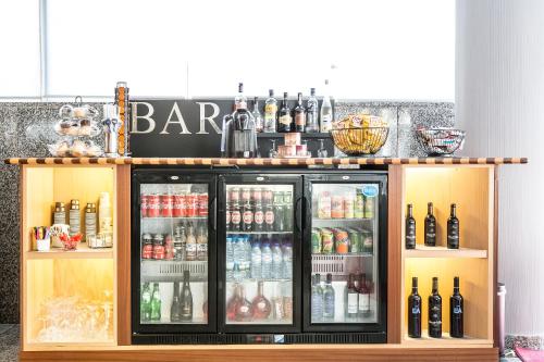a bar with drinks and bottles on top of it at Hotel 3K Madrid in Lisbon