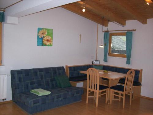 a living room with a couch and a table at Haus Gartenheim in Kals am Großglockner