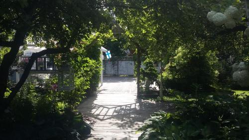 a garden path with trees and a fence at Lovely Mint Garden Studio in Vantaa