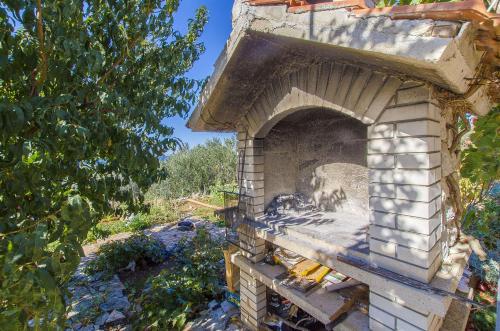 an outdoor brick oven with a painting on it at House Marija in Primošten