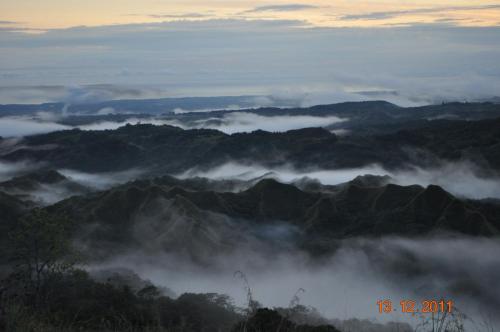 a view of a mountain range in the clouds at Hawk's Nest Bed & Breakfast in La Laguna de San Carlos