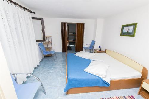 a hospital room with a bed and chairs at Apartments Milena in Rtina