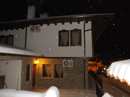 a house in the snow at night at Dragoevata Kashta in Kotel