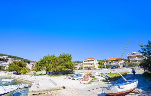 a boat parked on the beach next to some houses at Apartments Alen in Trogir