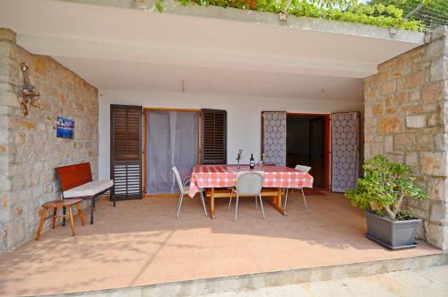 a red and white table and chairs on a patio at House Slavka in Gdinj