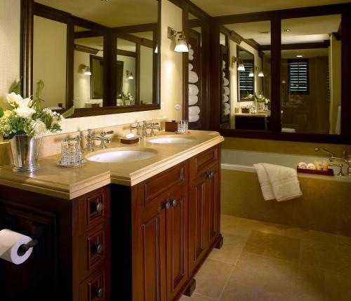 a bathroom with two sinks and a large mirror at The Brazilian Court Hotel in Palm Beach