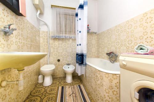a small bathroom with a sink and a toilet at Apartments Ban in Dugi Rat