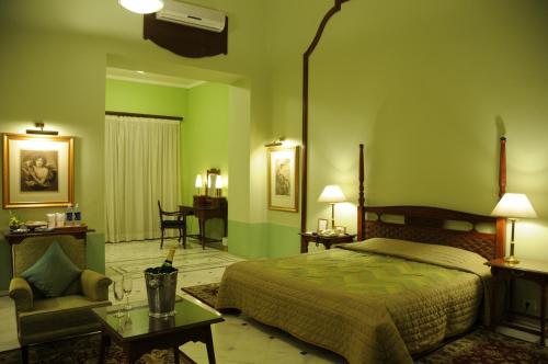 A bed or beds in a room at Palace Hotel - Bikaner House