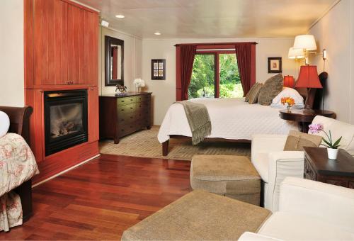 a bedroom with a bed and a fireplace at 1795 Acorn Inn Bed and Breakfast in Canandaigua