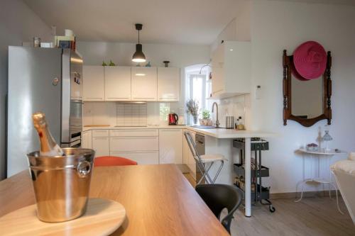 a kitchen with a wooden table with a bucket on it at Season4All Apartments in Mali Lošinj