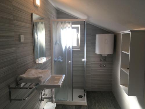 a bathroom with a shower and a sink at Apartments Suzana in Jakišnica