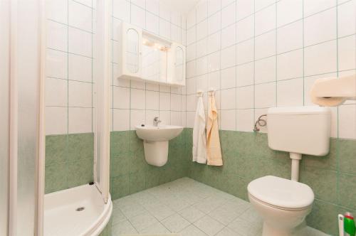 a bathroom with a toilet and a sink at Apartments Igor in Krvavica