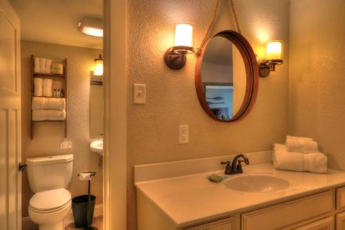 a bathroom with a sink and a toilet and a mirror at River Edge Inn in Gatlinburg