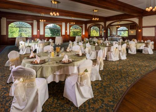 a banquet room with white tables and white chairs at The Stanley Hotel in Estes Park