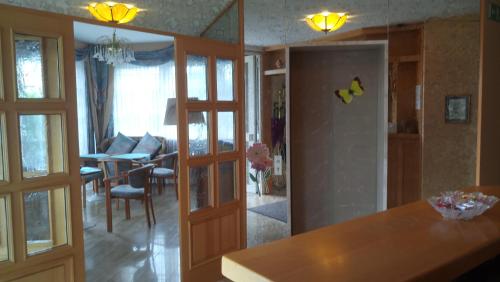 a kitchen and living room with sliding doors and a dining room at Kloesterle in Bad Steben