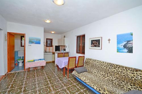 a living room with a couch and a table at Apartments Antun in Vrboska