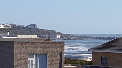 a view of the ocean from a house at Breakaway Apartment with Balcony in Yzerfontein