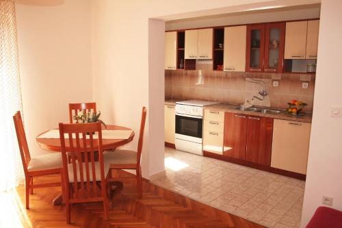 a kitchen with a table and a dining room at Apartment Anton in Slatine
