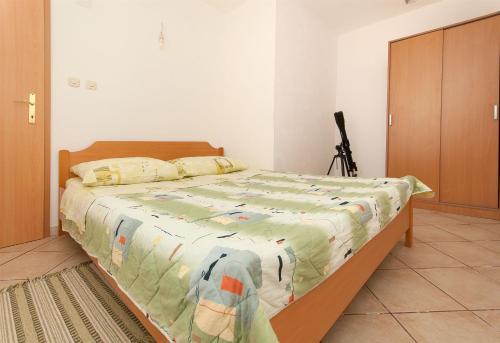 a bedroom with a large bed with a wooden frame at House Vela Lozna in Postira