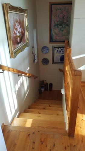a staircase in a home with a painting on the wall at Breakaway Apartment with Balcony in Yzerfontein