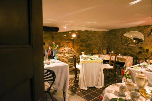 a restaurant with two tables with white table cloths at B&B Va...lentina in Piavata
