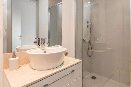 a white bathroom with a sink and a shower at Marbellamar apartamento in Mijas