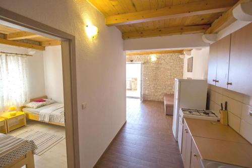 a kitchen and a bedroom with a bed in a room at Apartments Zeljko in Gdinj