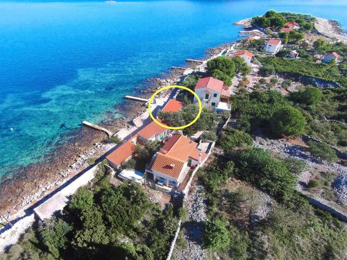 an island with a house with a yellow circle on it at House Mislav in Velike Kuknjare