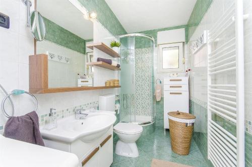 a bathroom with a white sink and a toilet at Holiday Home Nono in Sevid