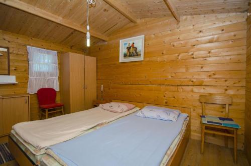 a bedroom with a bed in a wooden cabin at House Fisherman in Postira