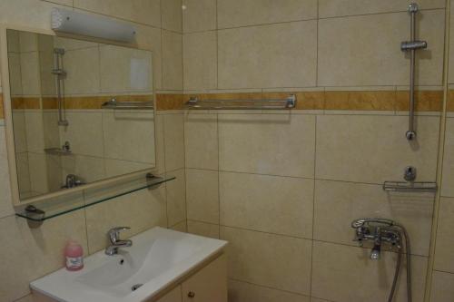 a bathroom with a sink and a mirror at Lydia Rooms & Studios in Preveza