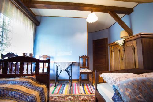 a bedroom with a bed and a chair and a window at OBERŻA in Borsuki