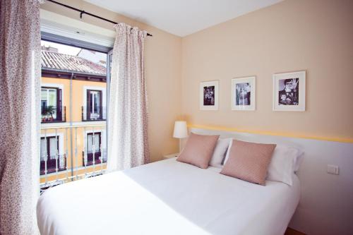 a bedroom with a large bed and a window at Apartment in the Centre in Madrid