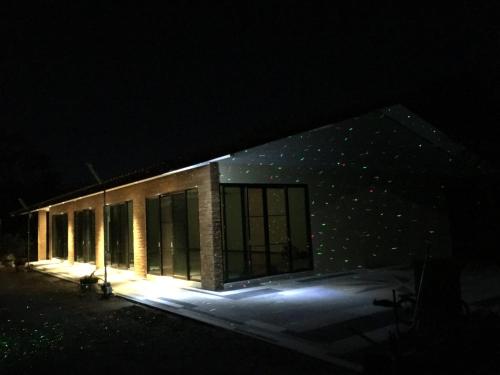 a building at night with lights on it at House of Garden in Chiang Rai