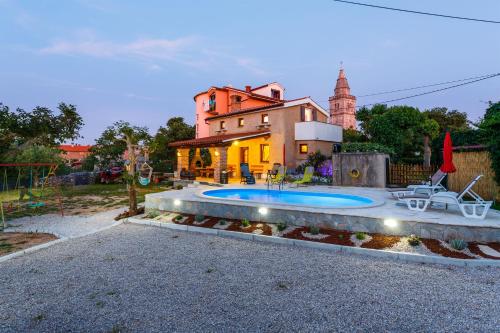 a house with a swimming pool in front of a house at House Poljica with a pool in Poljica