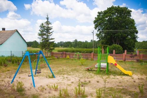 a playground with two swings in a yard at OBERŻA in Borsuki
