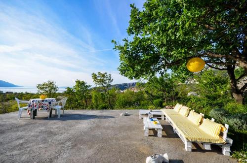 a group of benches sitting on top of a patio at Apartments Nina in Stinica