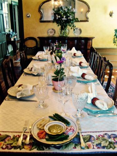 a table with plates and wine glasses on it at Millbrook Country House in Millbrook