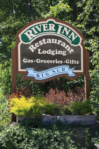 a sign for the river inn residential loading gas groceries cities at Big Sur River Inn in Big Sur
