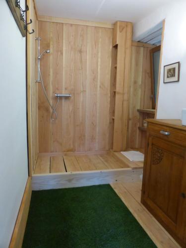 a bathroom with a shower with a green rug at La Bouriotte in Labastide-Rouairoux